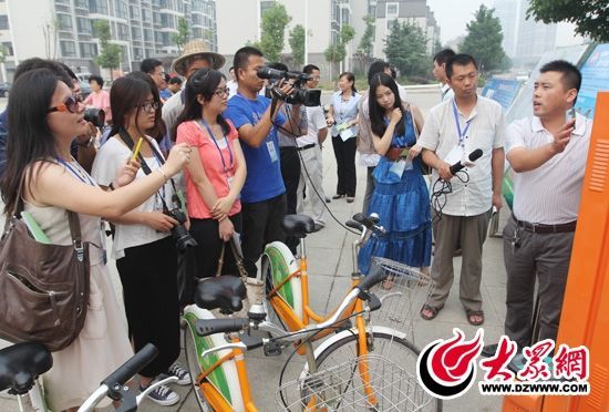 西線采訪團采訪了薛城區(qū)城市公共自行車服務(wù)系統(tǒng)，工作人員向記者們講解公共自行車的詳細(xì)情況。 記者 郭豪 攝。